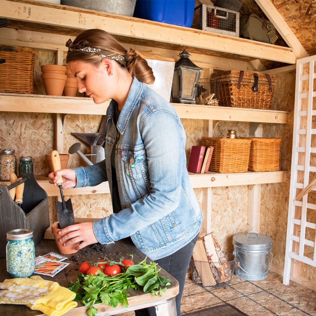 Woman working inside her gardening shed 