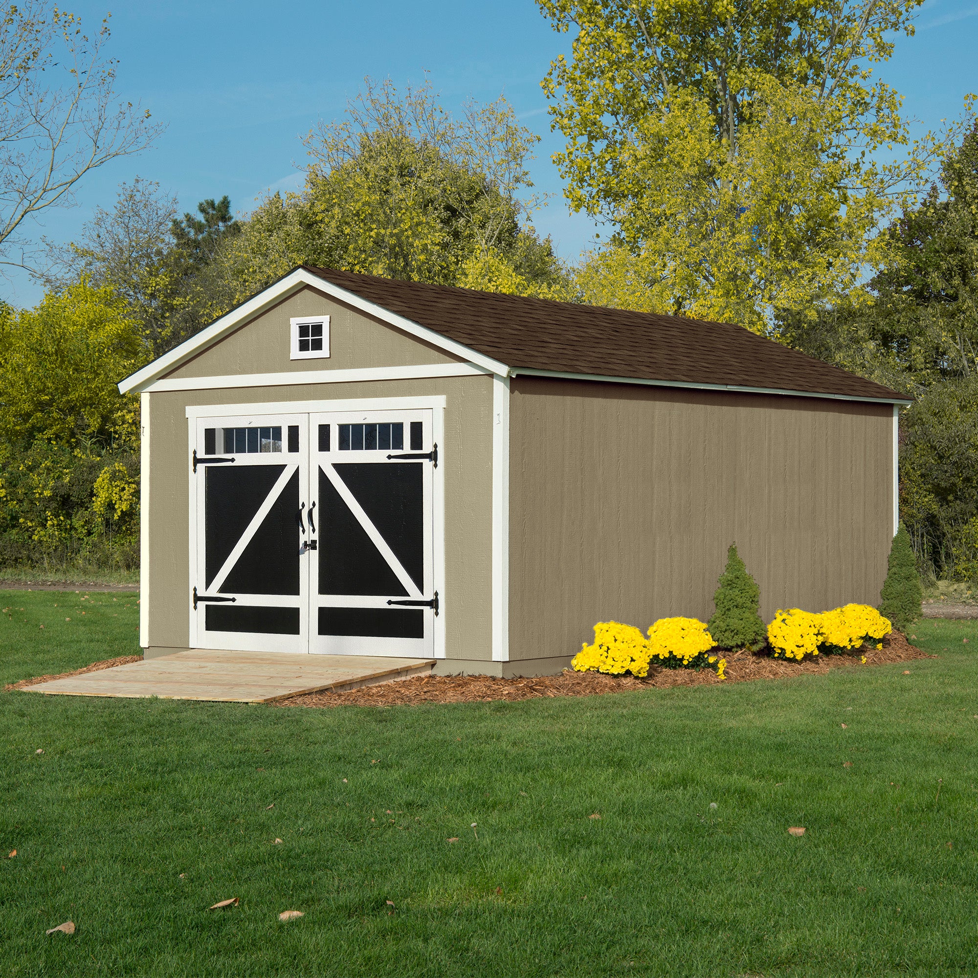 Storage shed with barn-style doors and a gable roof, surrounded by a well-maintained lawn and flower beds.