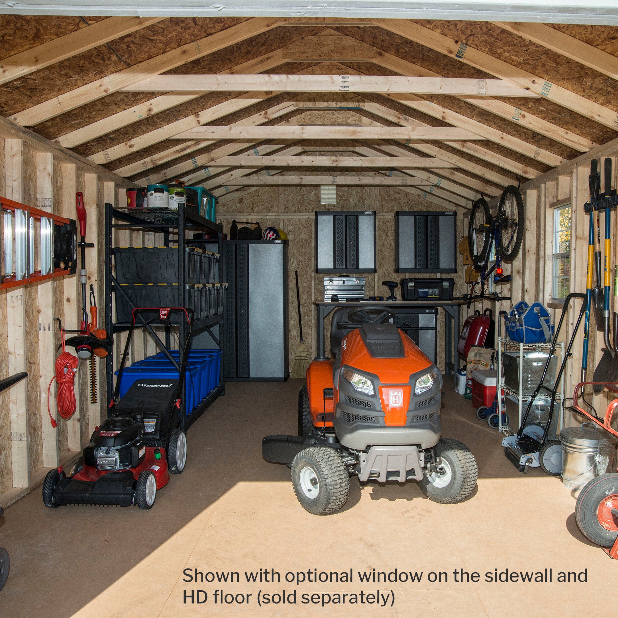 Interior of a shed with a lawn mower, shelves, and organized tools, providing ample storage space.