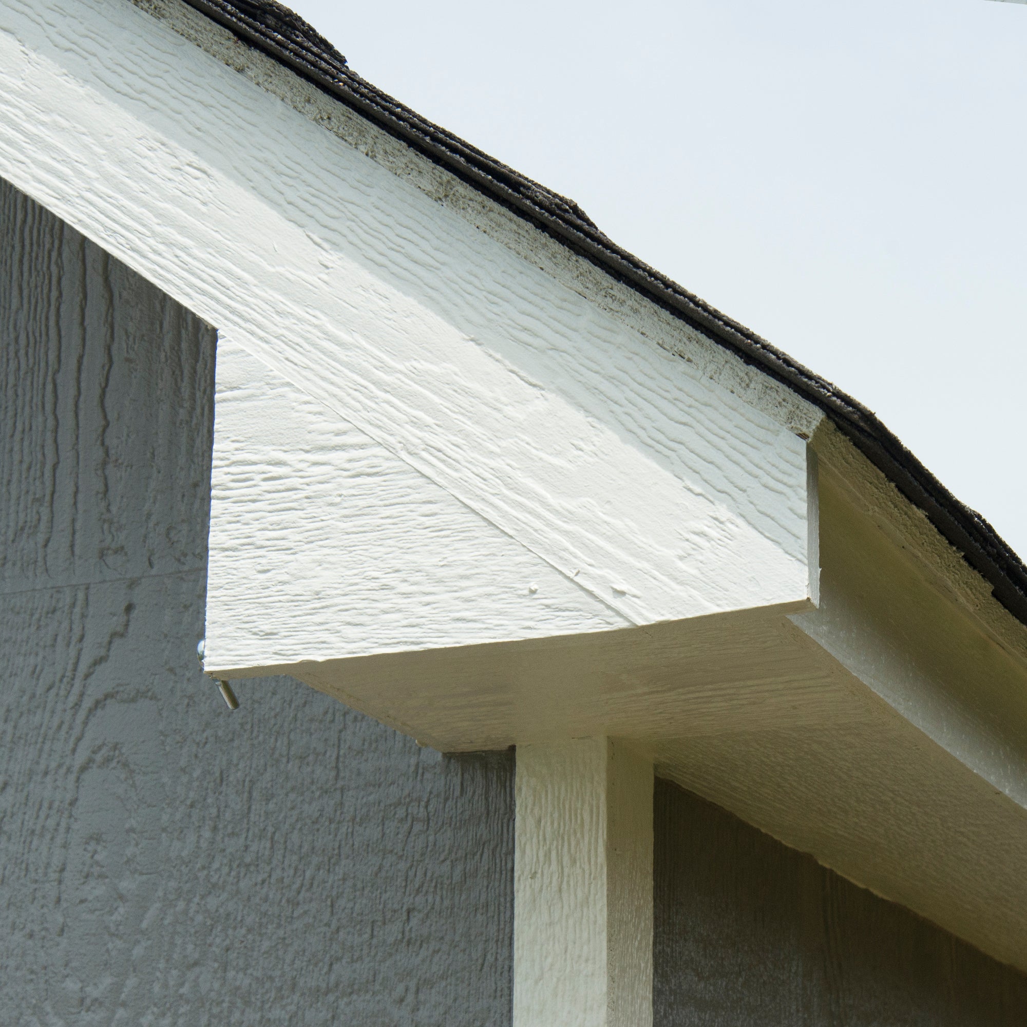 Close-up of a shed's roof overhang and trim detailing.